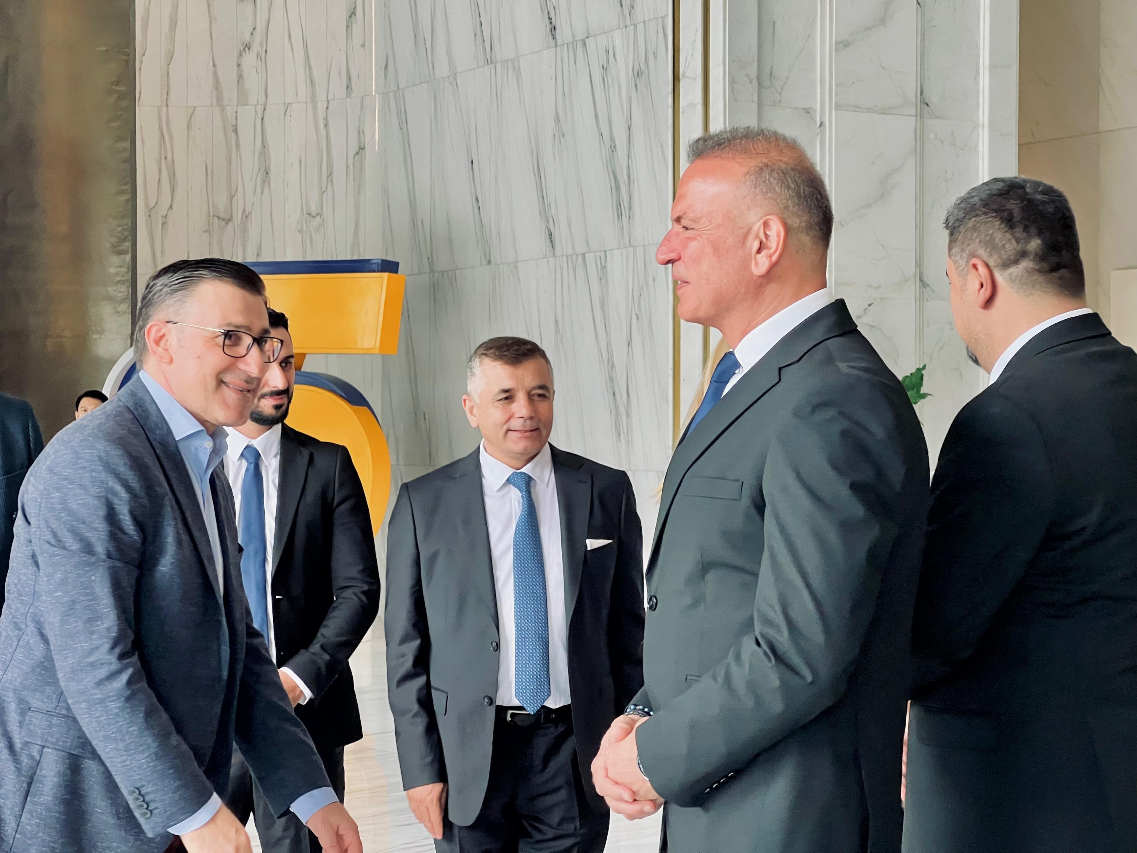 Kurumsal heyet üyelerinin resmi kabul alanında tokalaşarak görüştüğü an